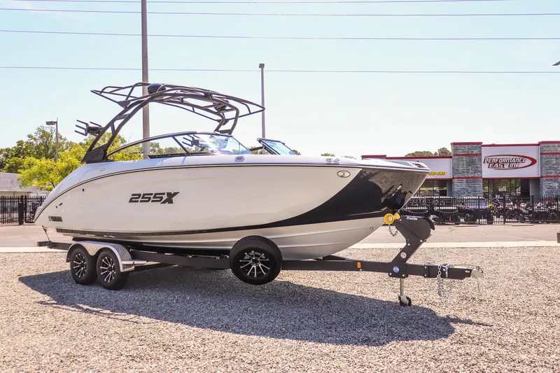 Slide: The Image of 2024 Yamaha Boats 255XD on trailer, sleek design, parked outdoors. - 3