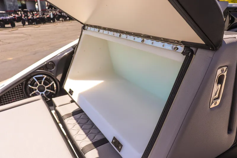 Slide: The Image of 2024 Yamaha Boats 255XD storage compartment open, showcasing spacious interior design. - 37