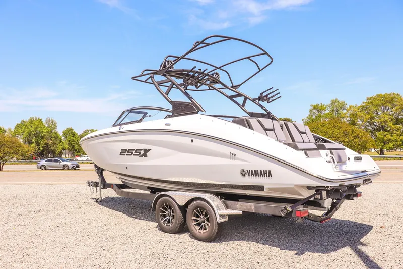 Slide: The Image of 2024 Yamaha Boats 255XD on trailer, sleek design, sunny day, outdoor setting. - 7