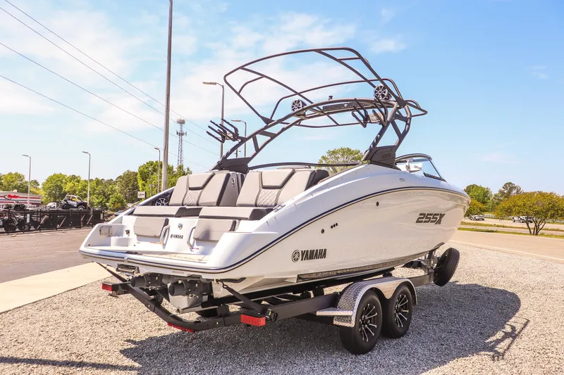Slide: The Image of 2024 Yamaha Boats 255XD on trailer, sleek design, sunny day, outdoor display. - 9