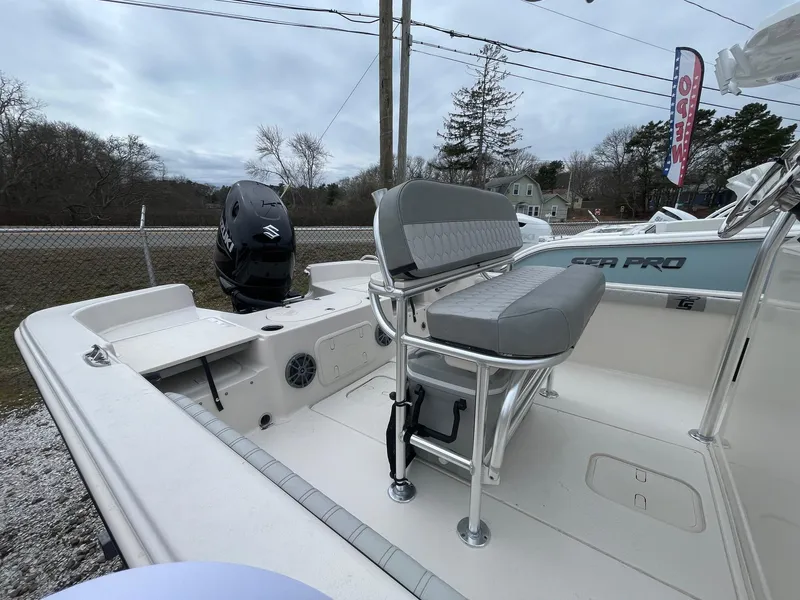 Slide: The Image of 2025 Carolina Skiff 21 LS boat with seating and outboard motor, displayed outdoors. - 10