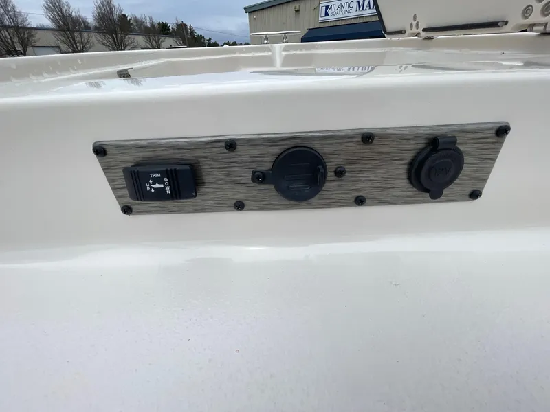 Slide: The Image of Control panel on a 2025 Carolina Skiff 21 LS boat, featuring switches and outlets. - 11