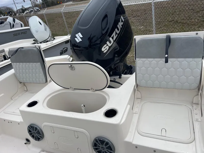 Slide: The Image of 2025 Carolina Skiff 21 LS boat with Suzuki outboard motor, featuring seating and storage compartments. - 13