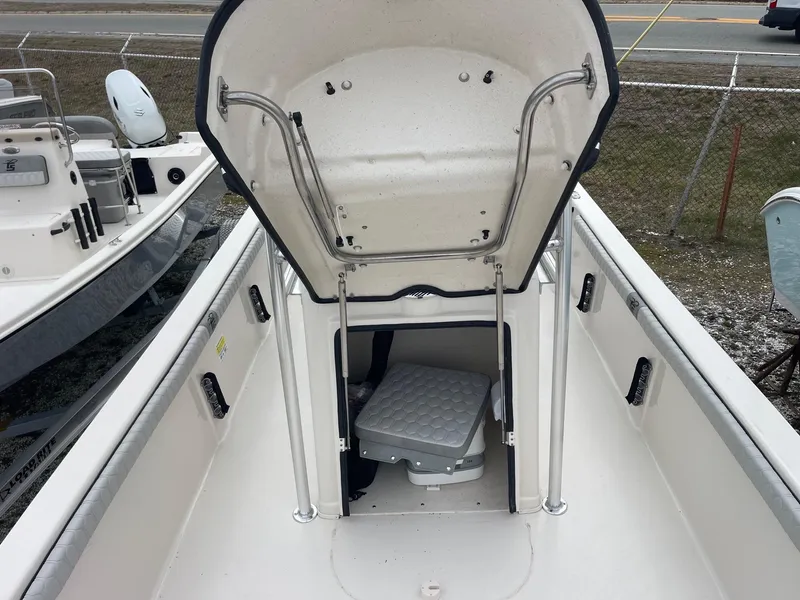 Slide: The Image of 2025 Carolina Skiff 21 LS boat interior with open storage compartment and seating. - 14