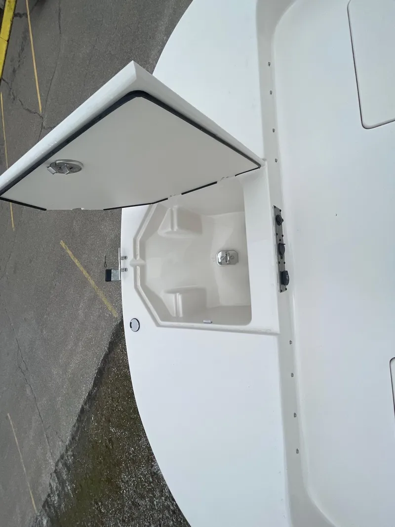 Slide: The Image of 2025 Carolina Skiff 21 LS boat with open storage compartment on deck. - 15