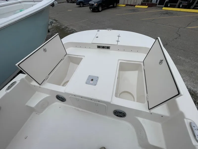 Slide: The Image of 2025 Carolina Skiff 21 LS boat deck with open storage compartments. - 16