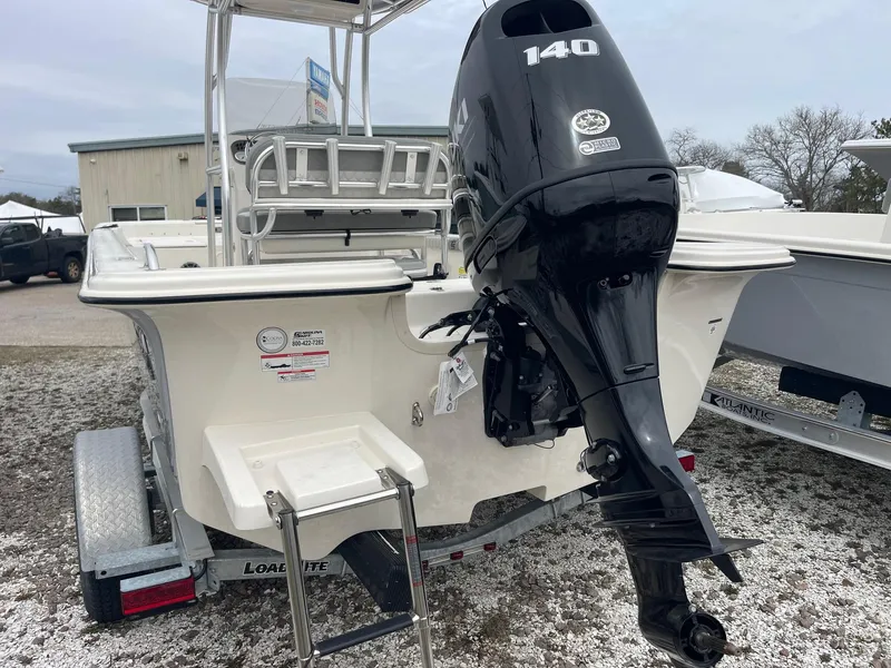 Slide: The Image of 2025 Carolina Skiff 21 LS boat with 140 HP outboard motor, on trailer. - 4