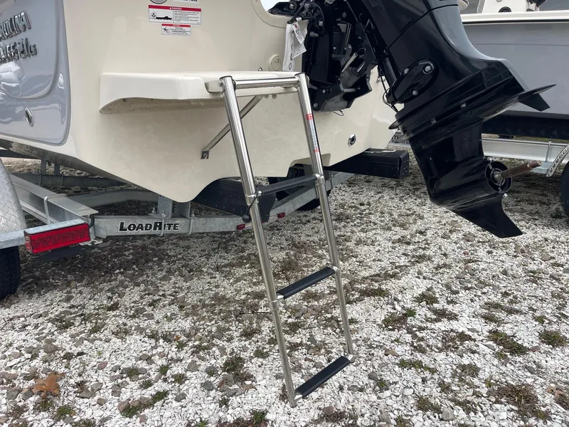 Slide: The Image of 2025 Carolina Skiff 21 LS boat with ladder and outboard motor on trailer. - 5