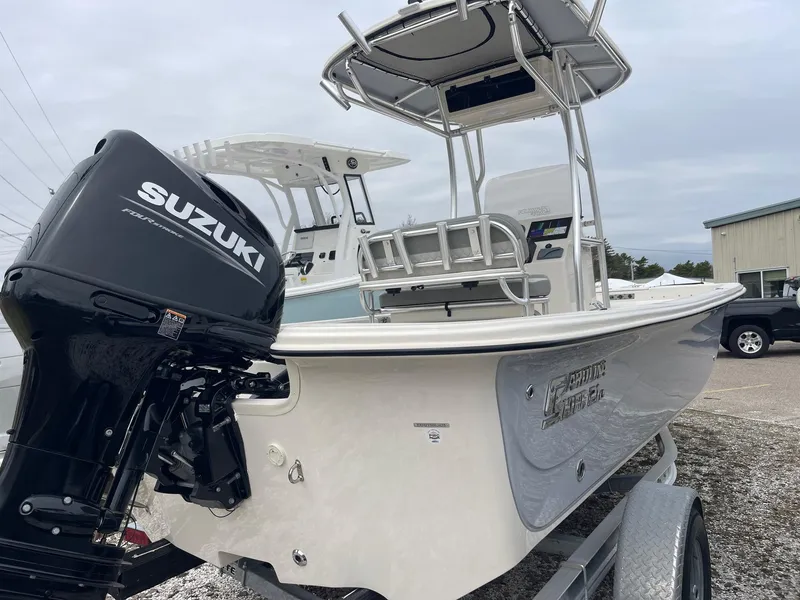 Slide: The Image of 2025 Carolina Skiff 21 LS boat with Suzuki outboard motor on trailer. - 6