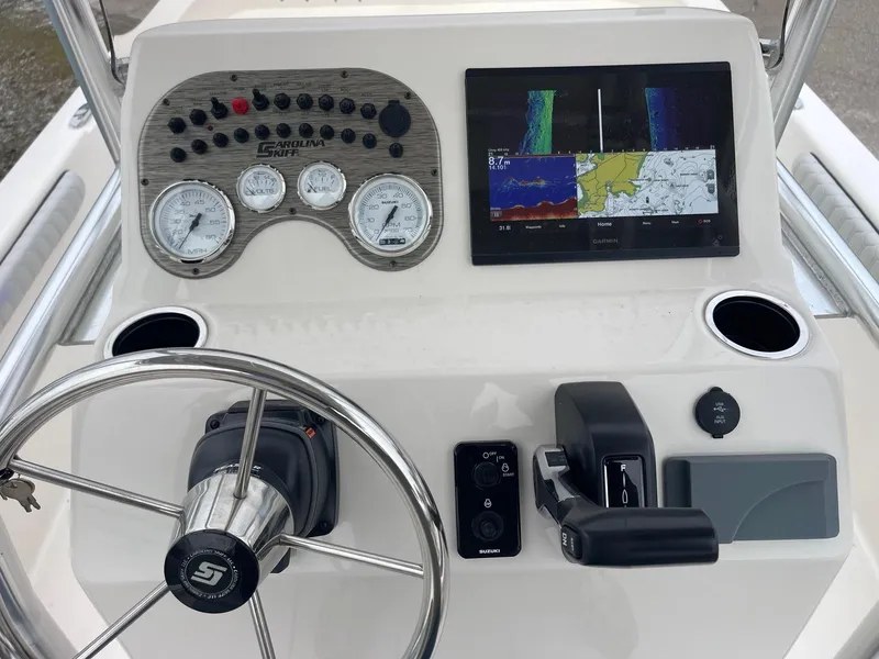 Slide: The Image of 2025 Carolina Skiff 21 LS dashboard with steering wheel, gauges, and navigation display. - 7