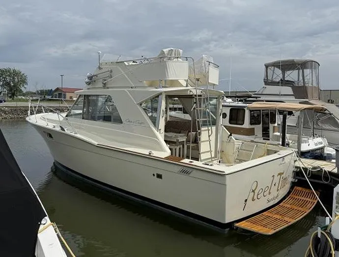 The Image of 1970 Chris-Craft Commander Sport Cruiser Fly Bridge docked at marina. - 0