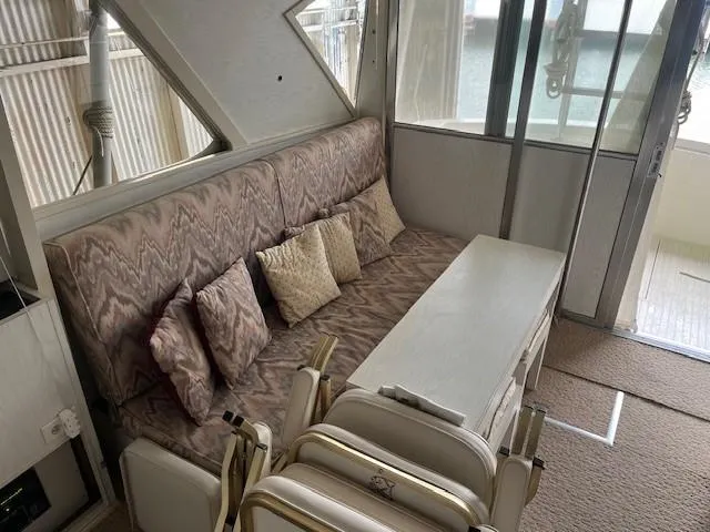 Slide: The Image of 1970 Chris-Craft Commander Sport Cruiser Fly Bridge with covered seats overlooking water. - 11