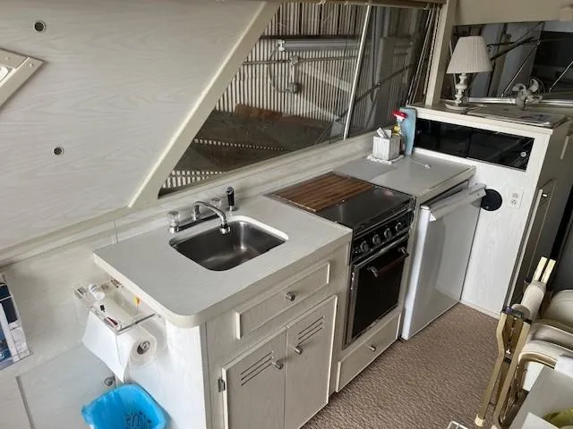 Slide: The Image of 1970 Chris-Craft Commander Sport Cruiser Fly Bridge in a boat shed. - 10