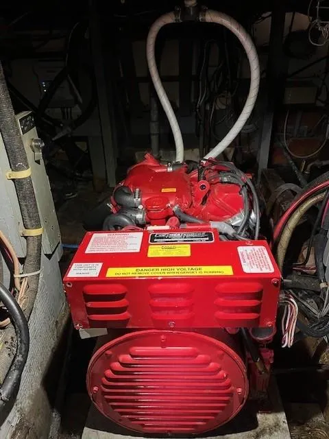 Slide: The Image of 1970 Chris-Craft Commander Sport Cruiser engine, vibrant red, detailed view in dimly lit engine room. - 14