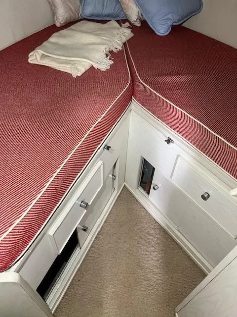 Slide: The Image of Interior of a 1970 Chris-Craft Commander Sport Cruiser with red cushions and white cabinetry. - 17