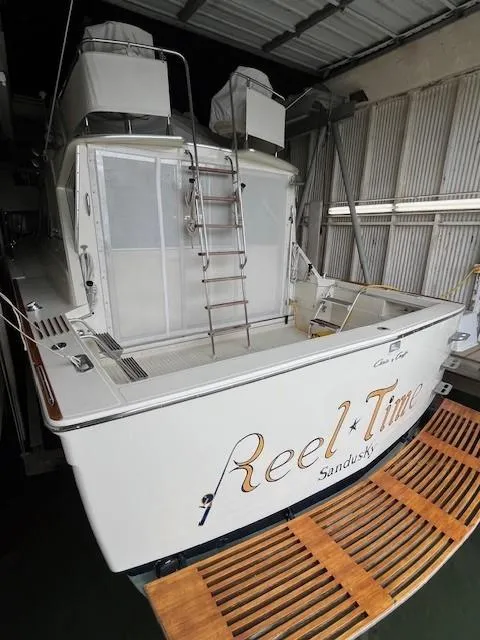 Slide: The Image of 1970 Chris-Craft Commander Sport Cruiser flybridge with Garmin navigation system and classic steering wheel. - 2