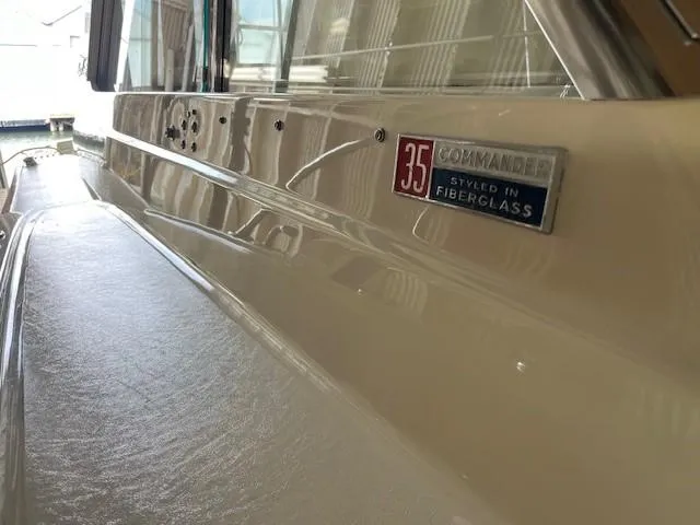 Slide: The Image of 1970 Chris-Craft Commander Sport Cruiser kitchen with sink, stove, and compact fridge. - 3