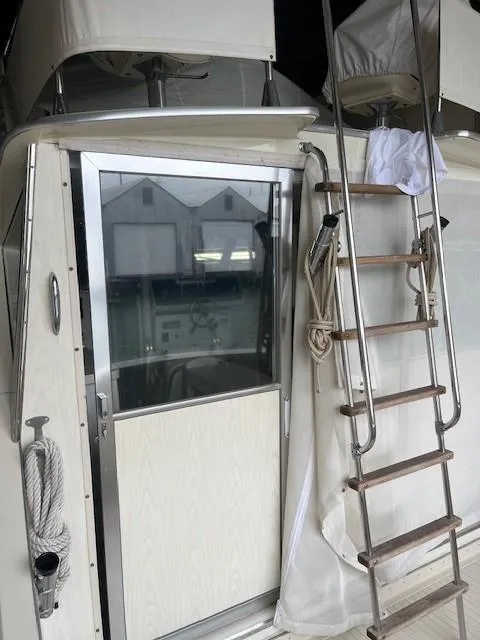 Slide: The Image of 1970 Chris-Craft Commander Sport Cruiser Fly Bridge docked in a covered marina. - 9