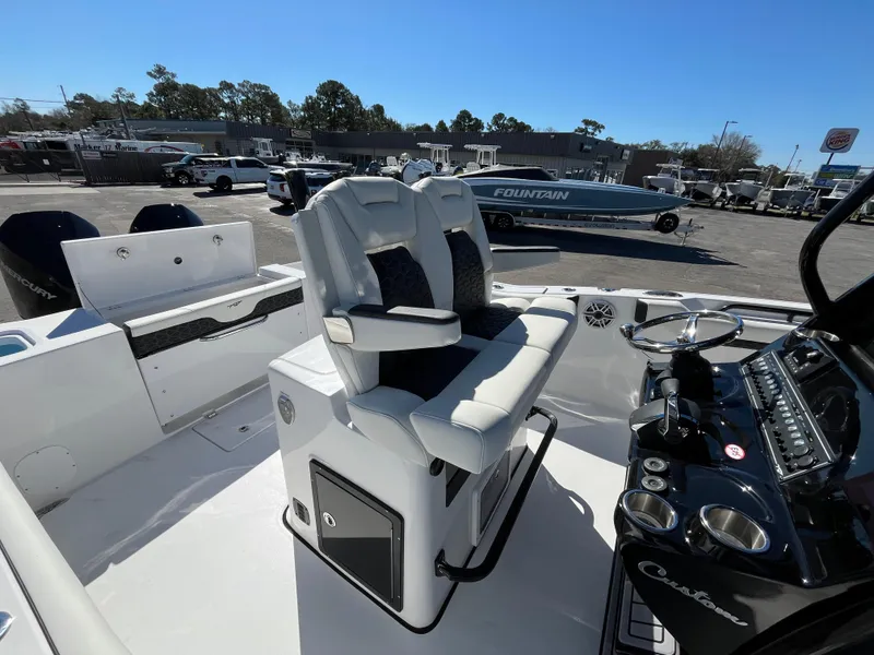 Slide: The Image of 2024 Tidewater 280 CC Adventure boat interior with dual captain's chairs and control panel. - 10