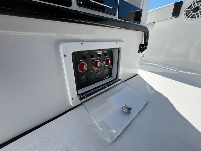 Slide: The Image of 2024 Tidewater 280 CC Adventure boat control panel with protective cover open. - 11
