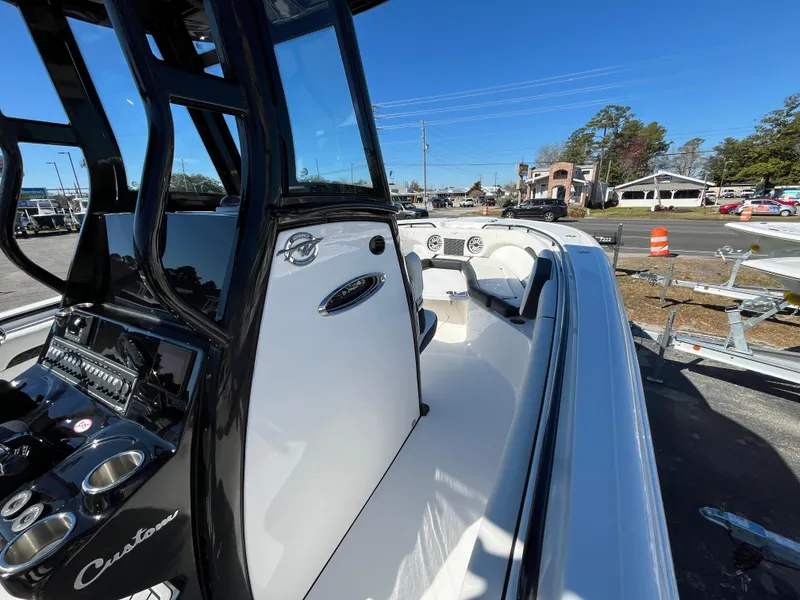 Slide: The Image of 2024 Tidewater 280 CC Adventure boat, sleek design, modern console, parked outdoors. - 14