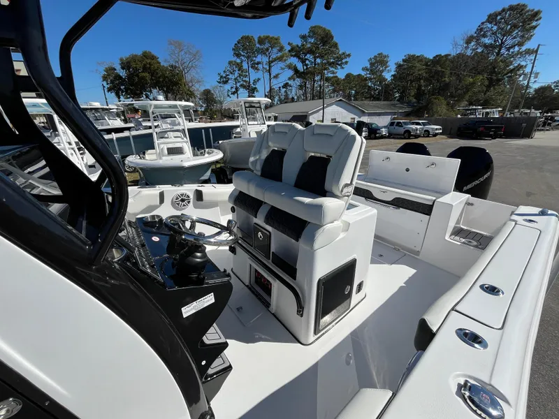 Slide: The Image of 2024 Tidewater 280 CC Adventure boat interior with seating and control panel. - 17
