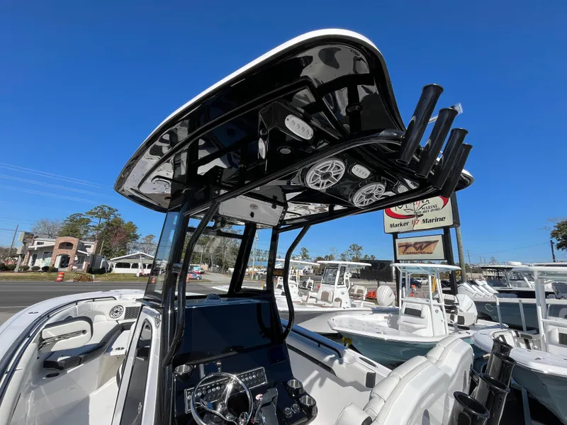 Slide: The Image of 2024 Tidewater 280 CC Adventure boat with sleek black T-top and modern dashboard. - 19