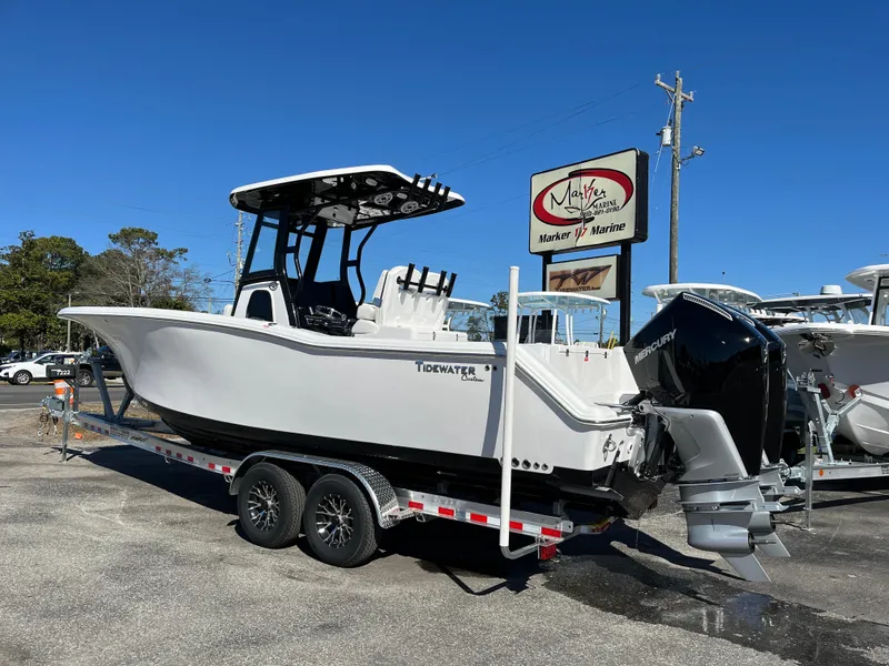 Slide: The Image of 2024 Tidewater 280 CC Adventure boat on trailer, displayed at a marine dealership. - 2