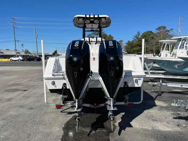 Slide: The Image of 2024 Tidewater 280 CC Adventure boat with dual outboard engines, parked on a sunny day. - 3
