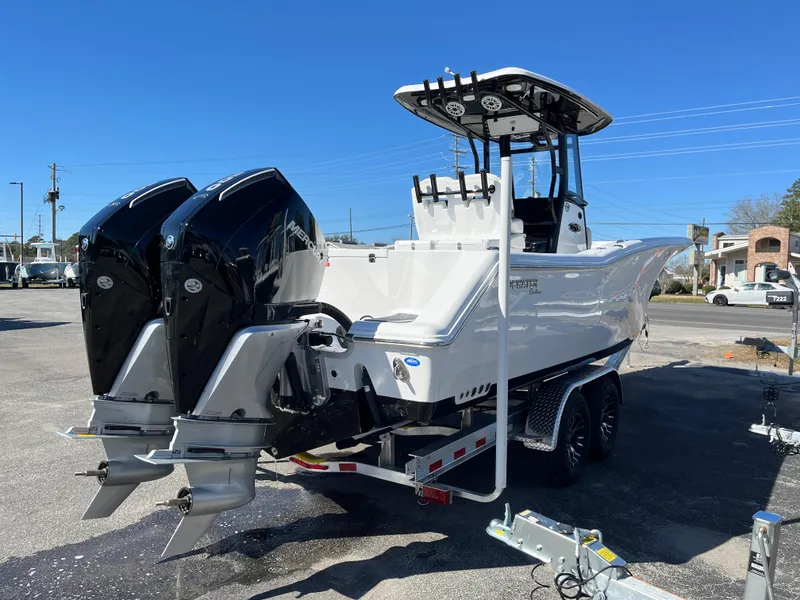 Slide: The Image of 2024 Tidewater 280 CC Adventure boat with dual engines on a trailer. - 4