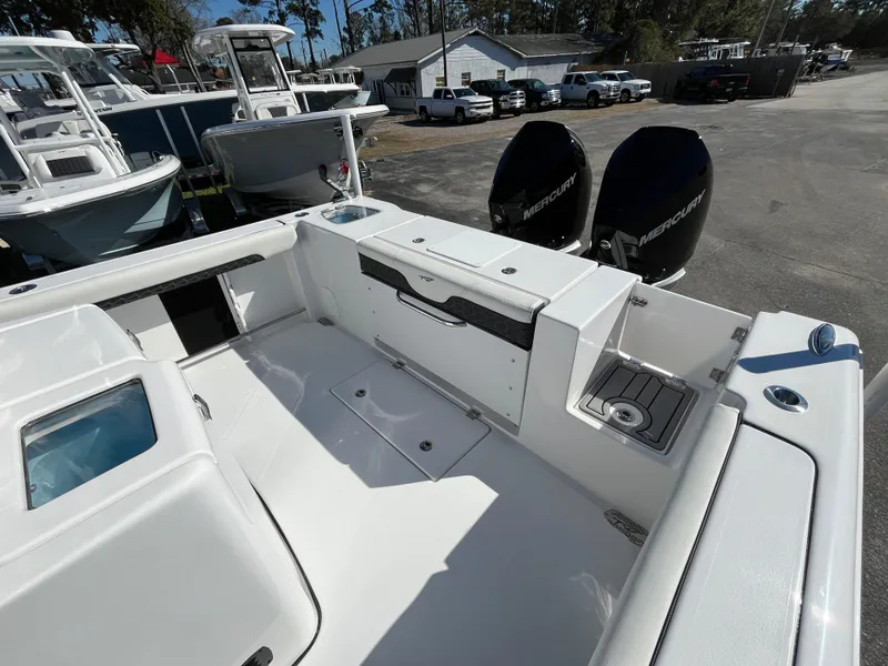 Slide: The Image of 2024 Tidewater 280 CC Adventure boat with dual Mercury engines, spacious deck, and modern features. - 6