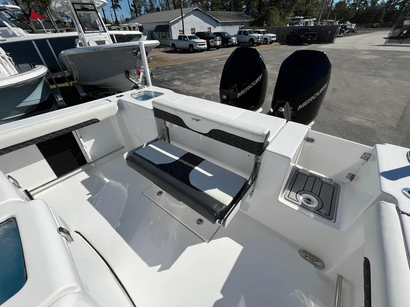 Slide: The Image of 2024 Tidewater 280 CC Adventure boat with dual Mercury engines and sleek seating. - 7