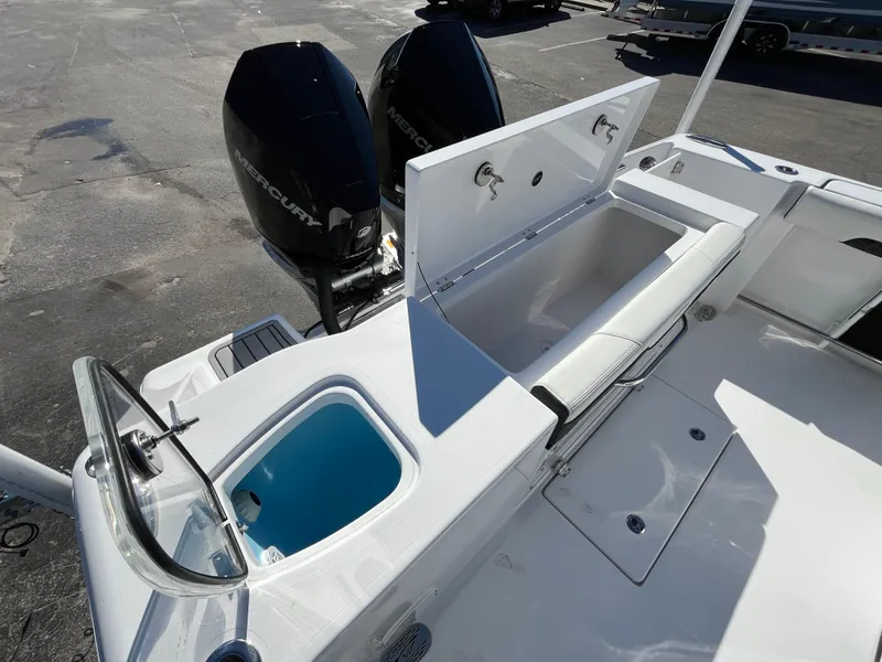 Slide: The Image of 2024 Tidewater 280 CC Adventure boat with open storage and dual Mercury engines. - 8