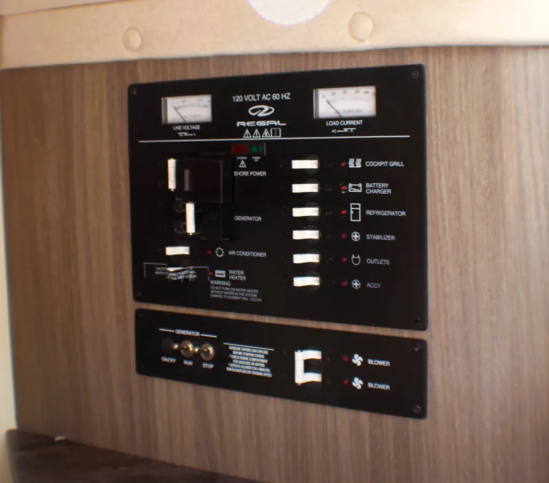Slide: The Image of Control panel of 2022 Regal 33 OBX boat with switches and indicators. - 18