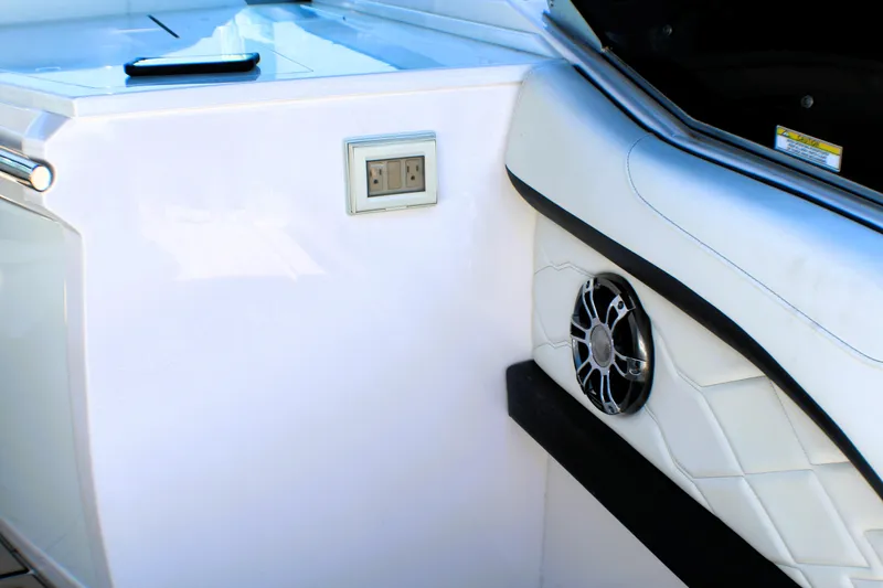 Slide: The Image of 2022 Regal 33 OBX boat interior with speaker and power outlet. - 21