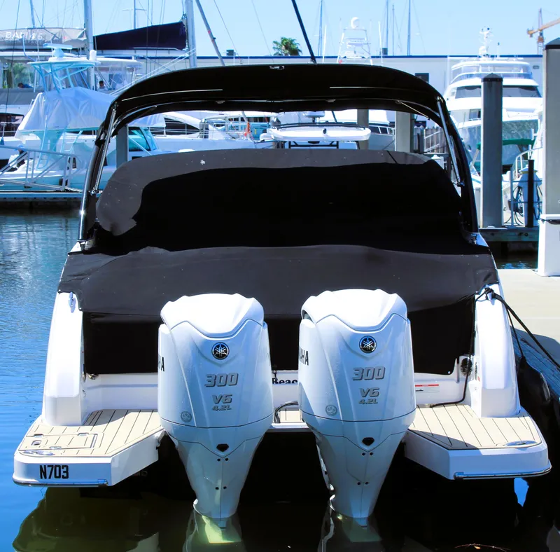 Slide: The Image of 2022 Regal 33 OBX boat with twin Yamaha 300 V6 engines docked at marina. - 24