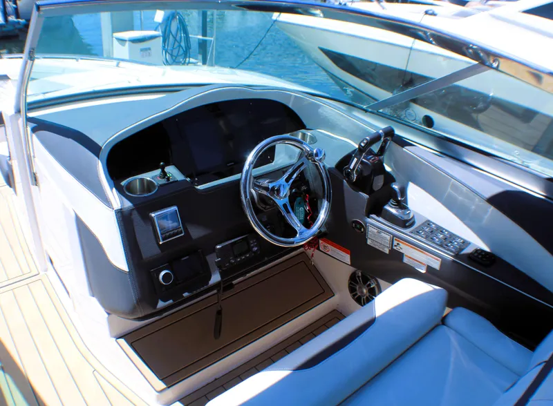Slide: The Image of 2022 Regal 33 OBX boat cockpit with modern steering and controls. - 4