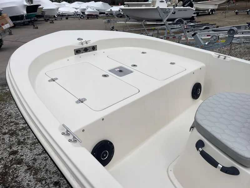 Slide: The Image of 2025 Carolina Skiff 162 JLS boat interior with storage compartments and seating. - 10