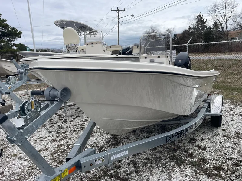 Slide: The Image of 2025 Carolina Skiff 162 JLS boat on trailer, parked outdoors. - 2