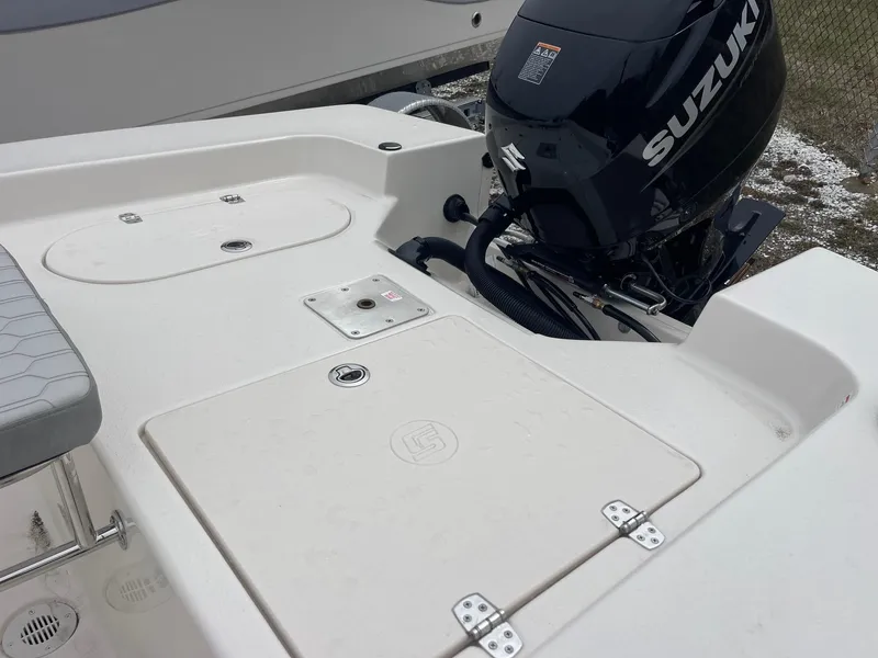 Slide: The Image of 2025 Carolina Skiff 162 JLS boat with Suzuki outboard motor, rear deck view. - 4