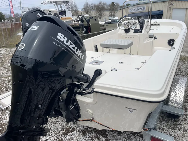 Slide: The Image of 2025 Carolina Skiff 162 JLS boat with Suzuki outboard motor on trailer. - 5