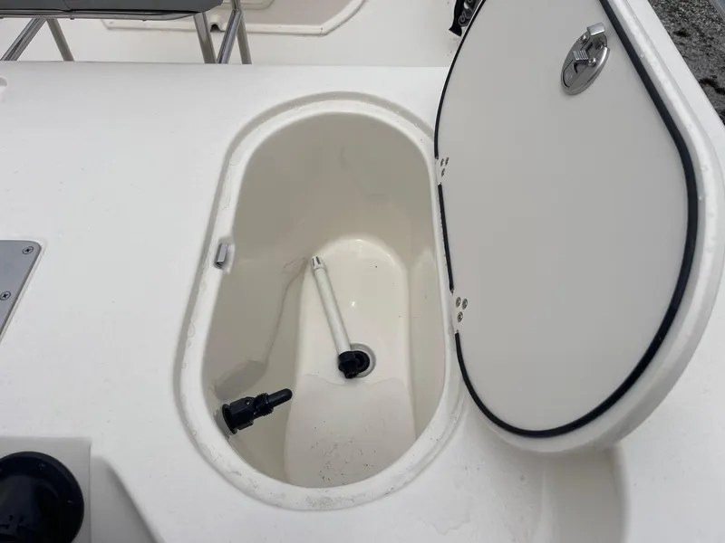Slide: The Image of 2025 Carolina Skiff 162 JLS boat compartment with open hatch, showcasing interior details. - 9
