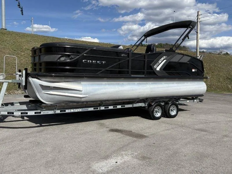 Slide: The Image of 2023 Crest Caribbean RS 230 SLC pontoon boat on trailer, parked outdoors. - 12