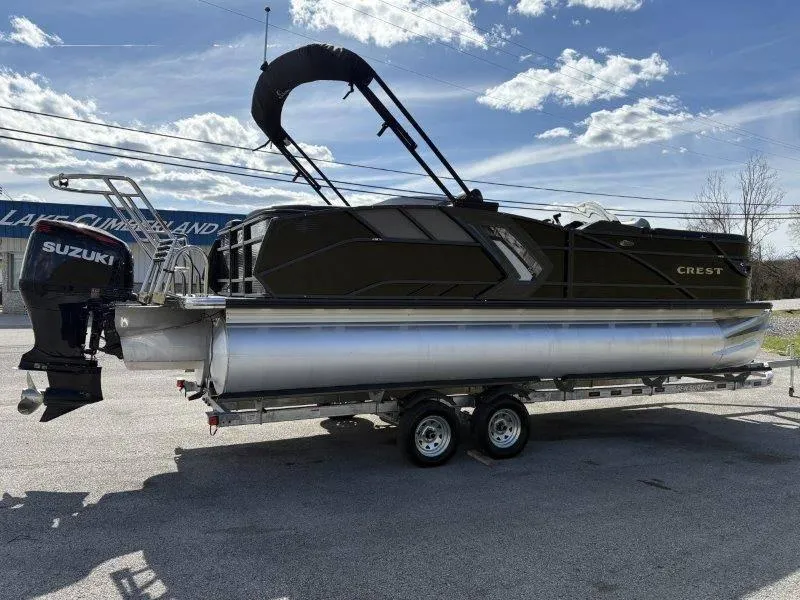 Slide: The Image of 2023 Crest Caribbean RS 230 SLC pontoon boat on trailer, featuring Suzuki outboard motor. - 15