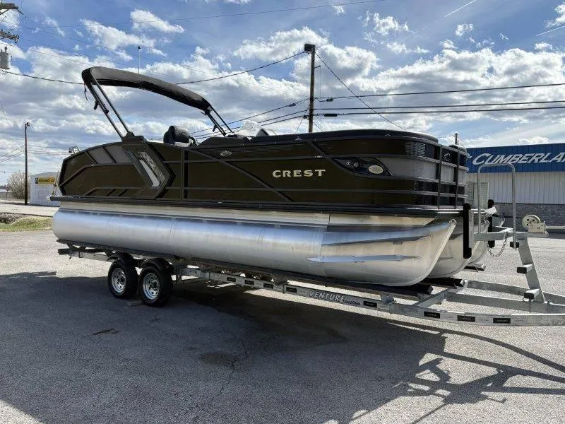 Slide: The Image of 2023 Crest Caribbean RS 230 SLC pontoon boat on trailer under cloudy sky. - 16