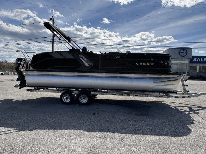 Slide: The Image of 2023 Crest Caribbean RS 230 SLC pontoon boat on trailer under cloudy sky. - 17