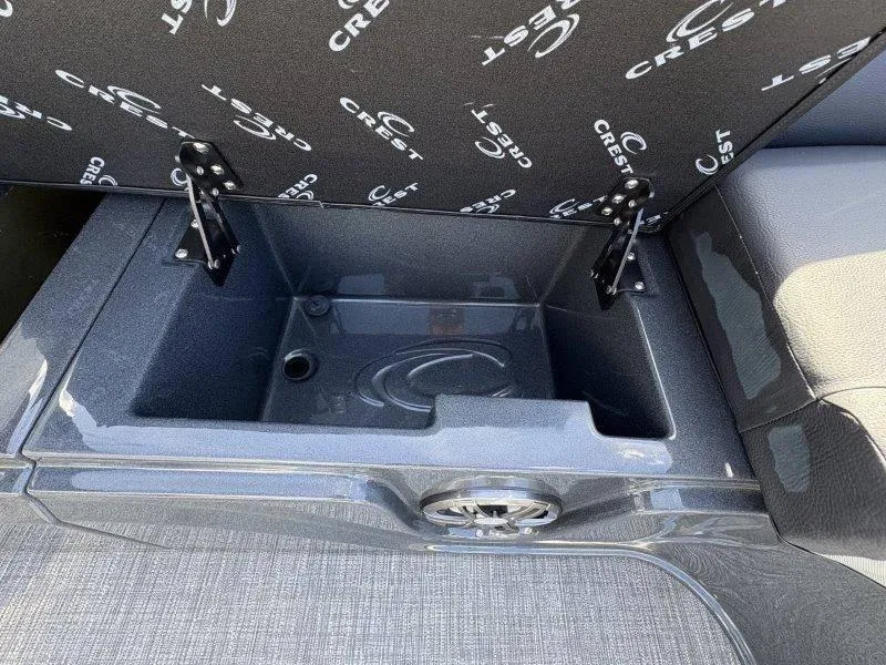 Slide: The Image of 2023 Crest Caribbean RS 230 SLC storage compartment with open lid and branded interior. - 24