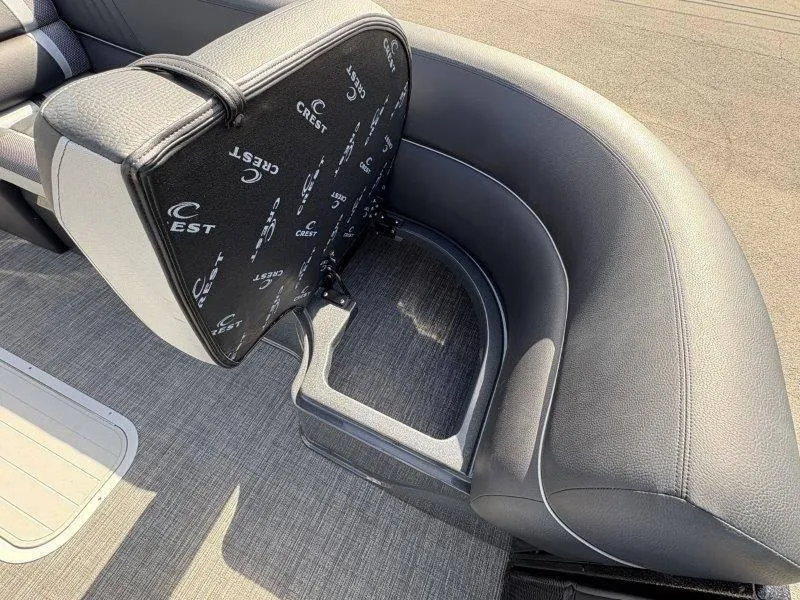 Slide: The Image of 2023 Crest Caribbean RS 230 SLC boat seat with storage compartment, featuring sleek black upholstery. - 29