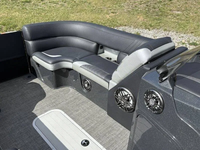 Slide: The Image of 2023 Crest Caribbean RS 230 SLC boat interior with curved seating and speakers. - 38