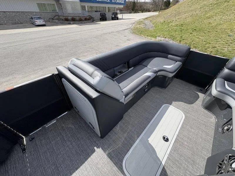Slide: The Image of 2023 Crest Caribbean RS 230 SLC boat interior with gray seating and carpeted flooring. - 40